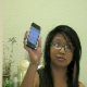 An Asian-American girl takes a shit sitting on a toilet while she is tweeting to her friends on her iPhone about her dump. The plop sound of her shit hitting the water is clearly heard, although we cannot see anything other than her upper body.